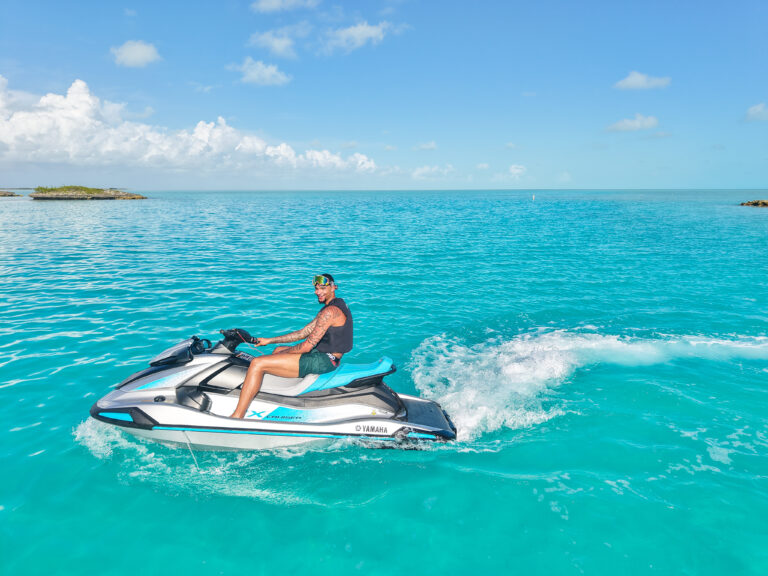 Rider cruising on a jet ski over clear turquoise water