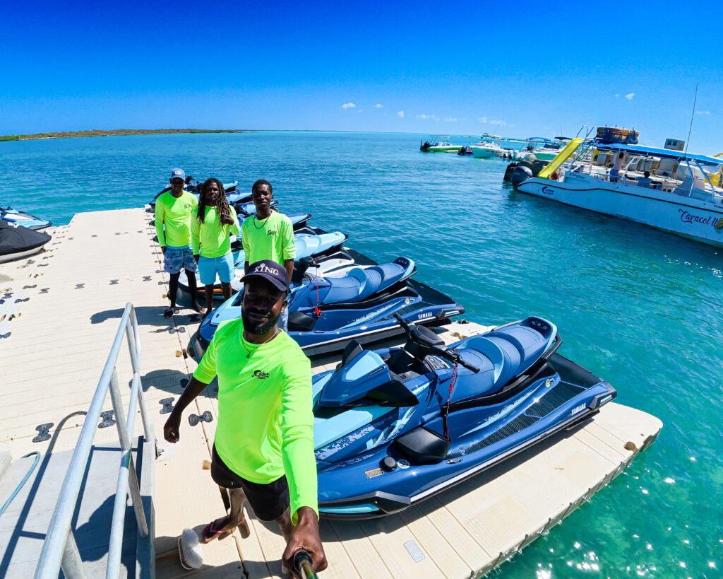 Jet Wave Turks guide on the dock beside a row of jet skis